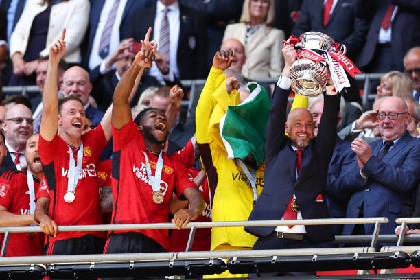 LONDON, ENGLAND - MAY 25: Erik ten Hag the head coach / manager of Manchester United lifts the FA Cup trophy during the Emirates FA Cup Final match between Manchester City and Manchester United at Wembley Stadium on May 25, 2024 in London, England.(Photo by Robbie Jay Barratt - AMA/Getty Images)